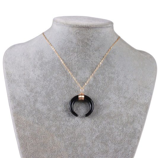 Short necklace with a crescent moon pendant.