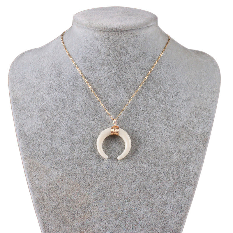 Short necklace with a crescent moon pendant.