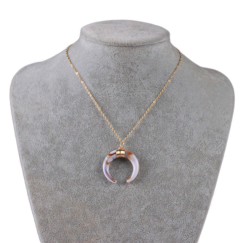 Short necklace with a crescent moon pendant.