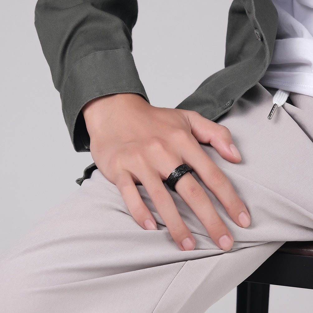 Retro rotating titanium steel tungsten ring with eye design.